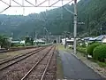A view of the tracks at the station, looking south. The siding can be seen branching off to the left.