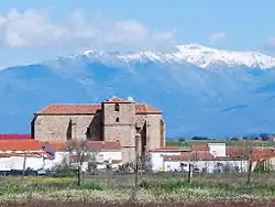 Church of St John the Baptist, Saucedilla  with the Sierra de Gredos snow-covered behind