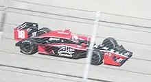 Wilson driving his car on a track
