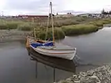 The replica of James Caird afloat in the river next to the Museum.