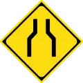 Road narrows on both sides