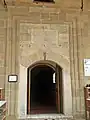 The entrance door of the mosque and its inscription