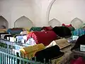 Tombs are decorated with blue glazed tiles and draped in colorful silks
