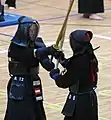 Two kendōka in tsuba zeriai.