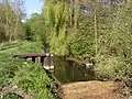 Kindelfließ-rivulet on the southern rim of Glienicke with the remains of the "water wall" that separated Glienicke (GDR) from West-Berlin.