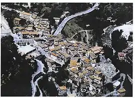 An aerial view of Lantosque, with the church of St Pons to the right, beside the cemetery