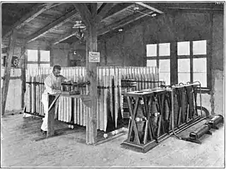 Telefunken 25&nbsp;kW long distance transmitter built 1906 at Nauen Transmitter Station, Nauen, Germany, showing large 360 Leyden jar 400&nbsp;μF capacitor bank (rear) and vertical spark gaps (right)