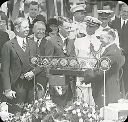 Lindbergh looks on as President Calvin Coolidge presents her son with the Distinguished Flying Cross (June&nbsp;11,&nbsp;1927)