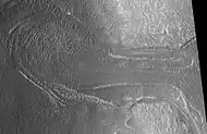 Probable glacier as seen by HiRISE under HiWish program. Radar studies have found that it is made up of almost totally of pure ice. It appears to be moving from the high ground (a mesa) on the right. Location is Ismenius Lacus quadrangle.
