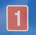 Route sign with white number on red background.