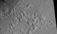 Surface features of Lycus Sulci, as seen by HiRISE under the HiWish program.