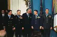 President Johnson congratulates Medal of Honor recipients at the White House on January 16, 1969. Lt. Col. Joe M. Jackson (on Johnson's left) and Major Stephen W. Pless (on Johnson's right) were both natives of the same small town of Newnan, GA and were both being honored for air rescues in Vietnam.