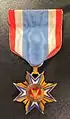 A membership medal worn by Brevet Col. Perrin V. Fox of the 1st Michigan Engineers.  His son later wore this medal as a descendant member.  Descendant members wore a ribbon with a blue stripe in the center until well into the twentieth century, when all members resumed using the red-center ribbon.