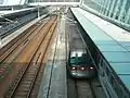 A Tung Chung line A-train at Sunny Bay station as viewed from the footbridge