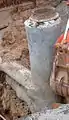 Installation of a sewer manhole. Typically only the top ring and cover (not pictured) would be visible.