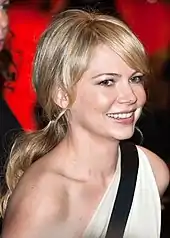 An upper body shot of a smiling Michelle Williams