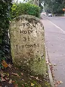 A mile stone on the old route of the A148, close to the center of Holt. Note the measurement in furlongs.