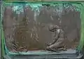 Relief (back) on the socket of the sculpture in Vänersborg
