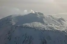  Distant view of a mountain with a smoke emission from its summit