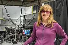 NIST physicist Elizabeth Donley with a compact atomic clock design that could help improve precision in ultraportable clocks.