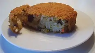 A nasischijf&nbsp;[nl] cut open showing the fried rice inside the deep fried snack