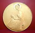 Nativity, a gilded silver medallion with an emerald and zapphires by Renato Signorini.