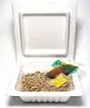 Nattō is sold in small containers optionally with small packets of tsuyu sauce with and without mustard.