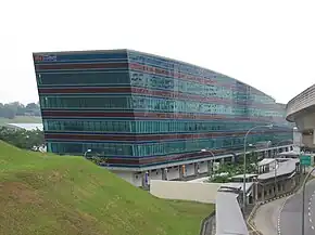 View of a glass-covered blue building (the depot administrative building) along a road
