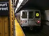 An R46 R train leaving the station