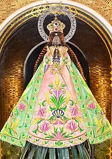 Nuestra Señora de Guia enshrined in Ermita Church, widely venerated among travellers and seafarers. Pandan foliage decorating her base is reminiscent of its syncretic worship in early colonial Manila.