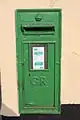 George V wall box showing small red specks under the green paint at Tullamore