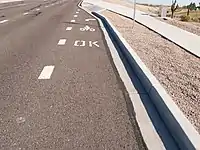 Pavement markings indicate sidewalk riding is legal.