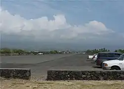 The runway is now an access road and a parking lot