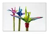 Tiny origami cranes on match heads