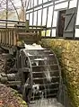 Skovmøllen, showing the waterwheel at work.