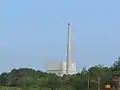 A close-up view of the Oyster Creek complex with the reactor building & off gas stack.