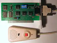 An internally mounted PC card with a serial port connected to a small controller.