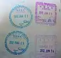 Entry and exit stamps issued at Port of Busan, depicting sea vessels
