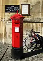A Victorian hexagonal red post box of the Penfold type manufactured in 1866 outside King's College, Cambridge (not the original location for this box).