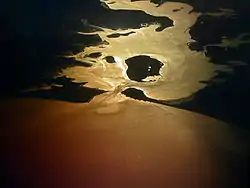 Aerial view of the harbour entrance, looking west-north-west. The large island just inside the entrance is Brownsea Island; to its left are Furzey Island and then Green Island.