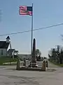 Warld War I veterans memorial in Pickrelltown (2010 photo).  The 8&nbsp;ft (2.4&nbsp;m) high granite monument was erected in 1921, and has twice been rebuilt after vehicles crashed into it.