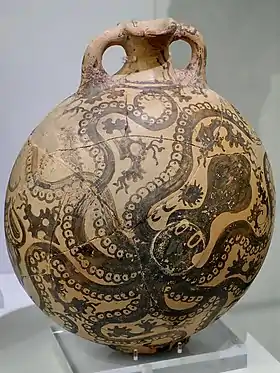 Small, painted jug with a spout and handle