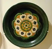 A rounded "offering plate" with design in "three colors" (sancai) glaze, 8th-century