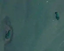 An aerial photograph of two small islands separated by water