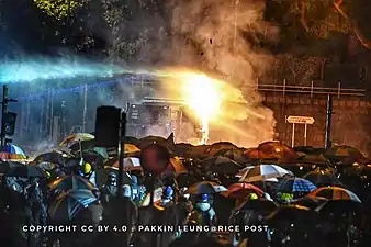 Police using a water cannon truck