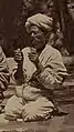 Musician plays a pair of qairaq in each hand