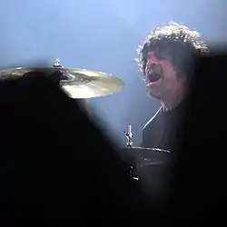 Castillo performing with Queens of the Stone Age in 2011.