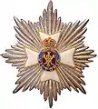 The royal and imperial Cypher of Queen Victoria forms a part of the emblem of the Royal Victorian Order surrounded by a Brunswick star