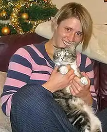 Coriam snuggling a cat