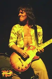On stage playing guitar in 1974